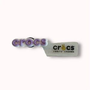 FREE WITH $30+ Crocs lavender logo Jibbitz